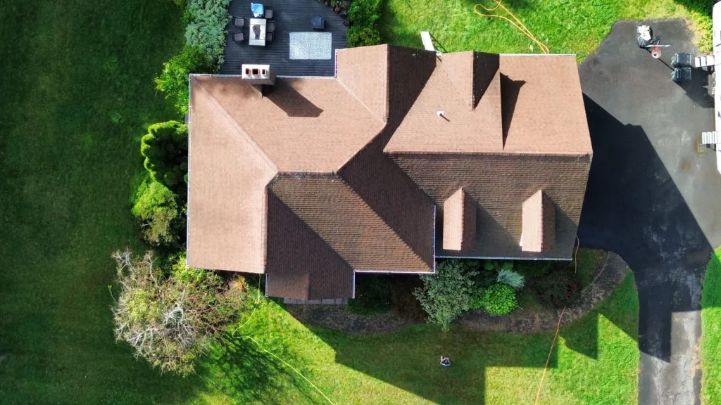 roof-cleaning-company-hartford-county-ct Wicked Clean roof cleaning crew in Hartford County CT — professional soft wash equipment next to residential rooftop