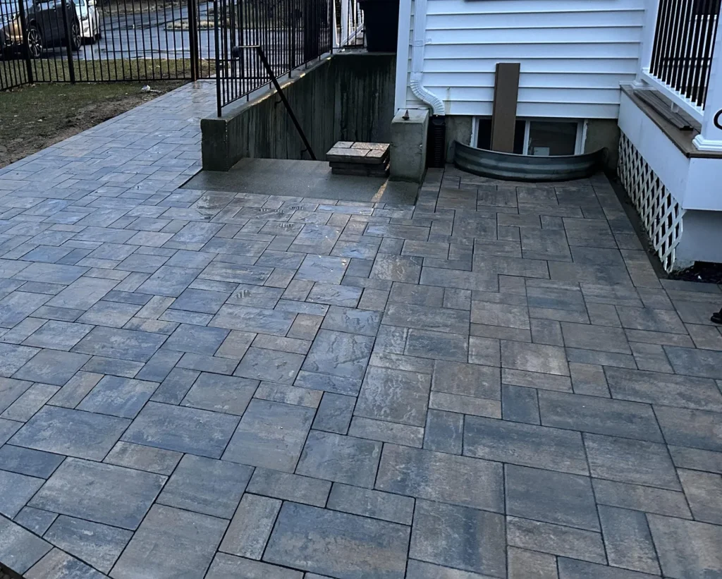 paver-sealing-hartford-county-ct Paver sealing in Hartford County CT — professional applying sealant to brick paver driveway and patio after cleaning